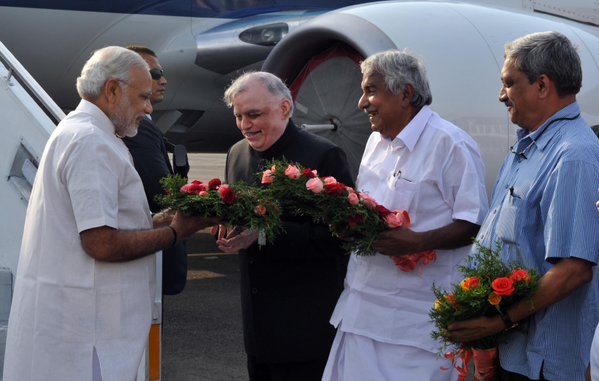Governor P. Sathasivam and Chief Minister Oommen Chandy receiving Prime Minister Narendra Modi in Kochi on Monday