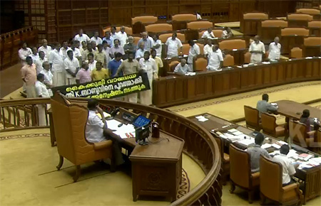Opposition protesting with banners in the well of the Assembly on Wednesday
