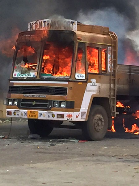 A truck set on fire by protestors in Bangalore on Monday